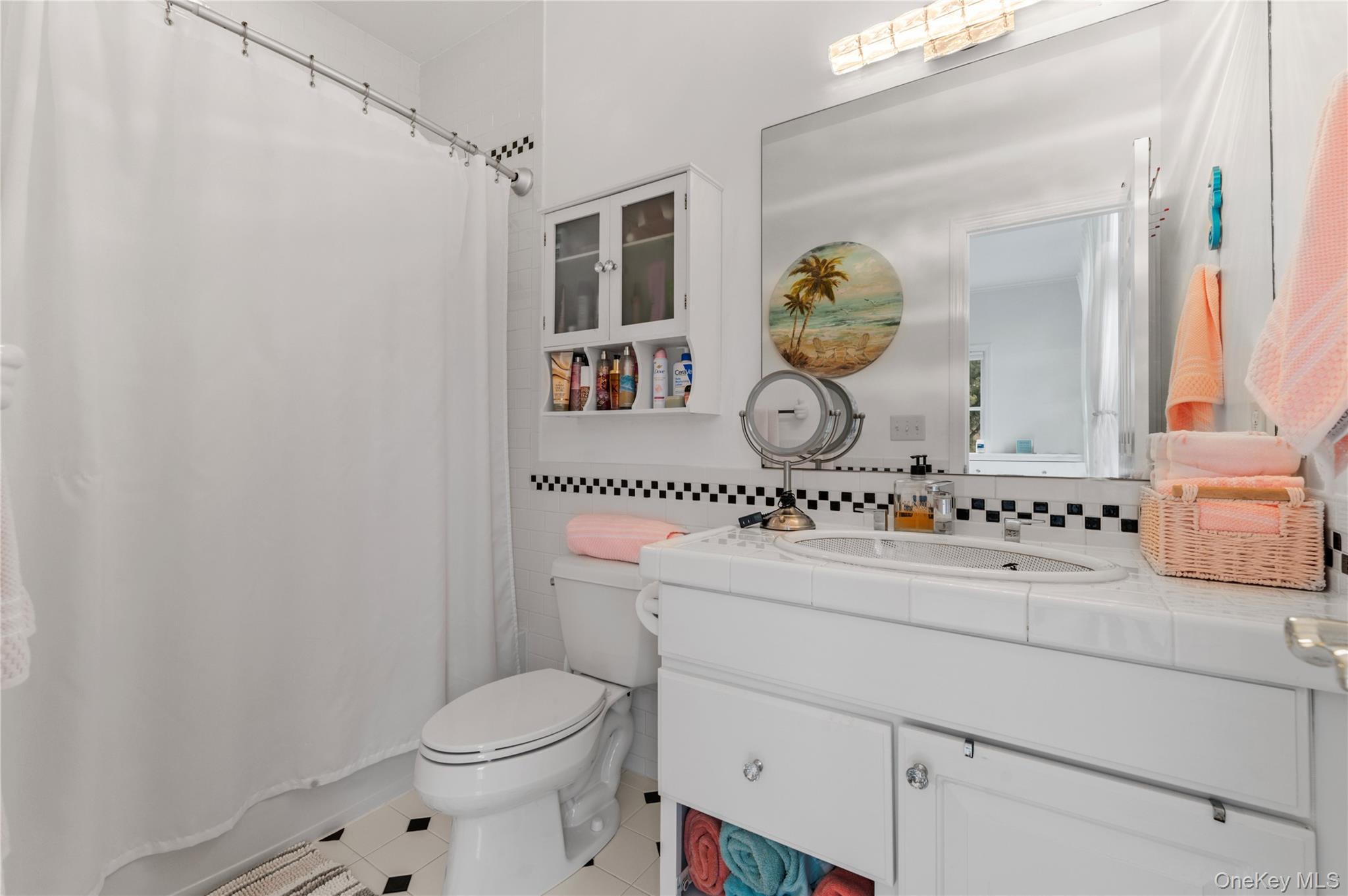 14 South Country Road Westhampton, NY 11977 - Photo 19 of 45 a bathroom with a toilet sink and mirror