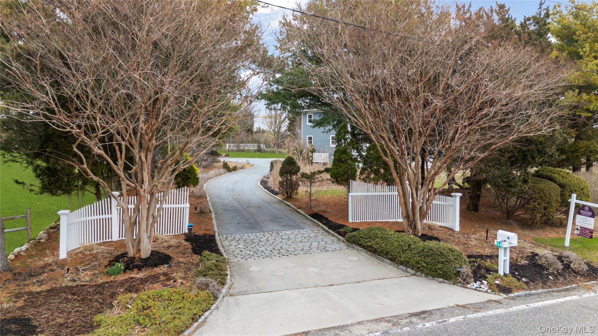 14 South Country Road Westhampton, NY 11977 - Photo 2 of 45 a view of a yard with plants and a large tree