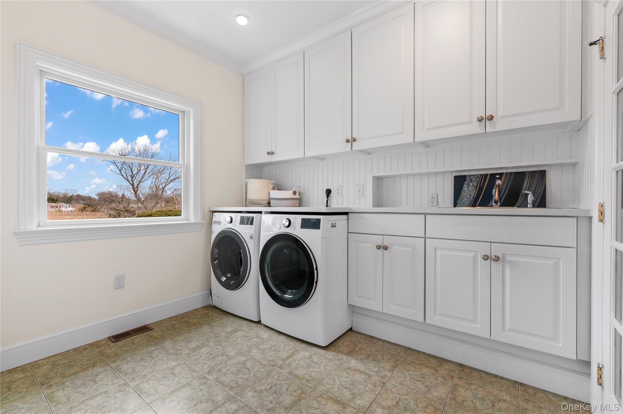 14 South Country Road Westhampton, NY 11977 - Photo 22 of 45 a utility room with sink dryer and washer