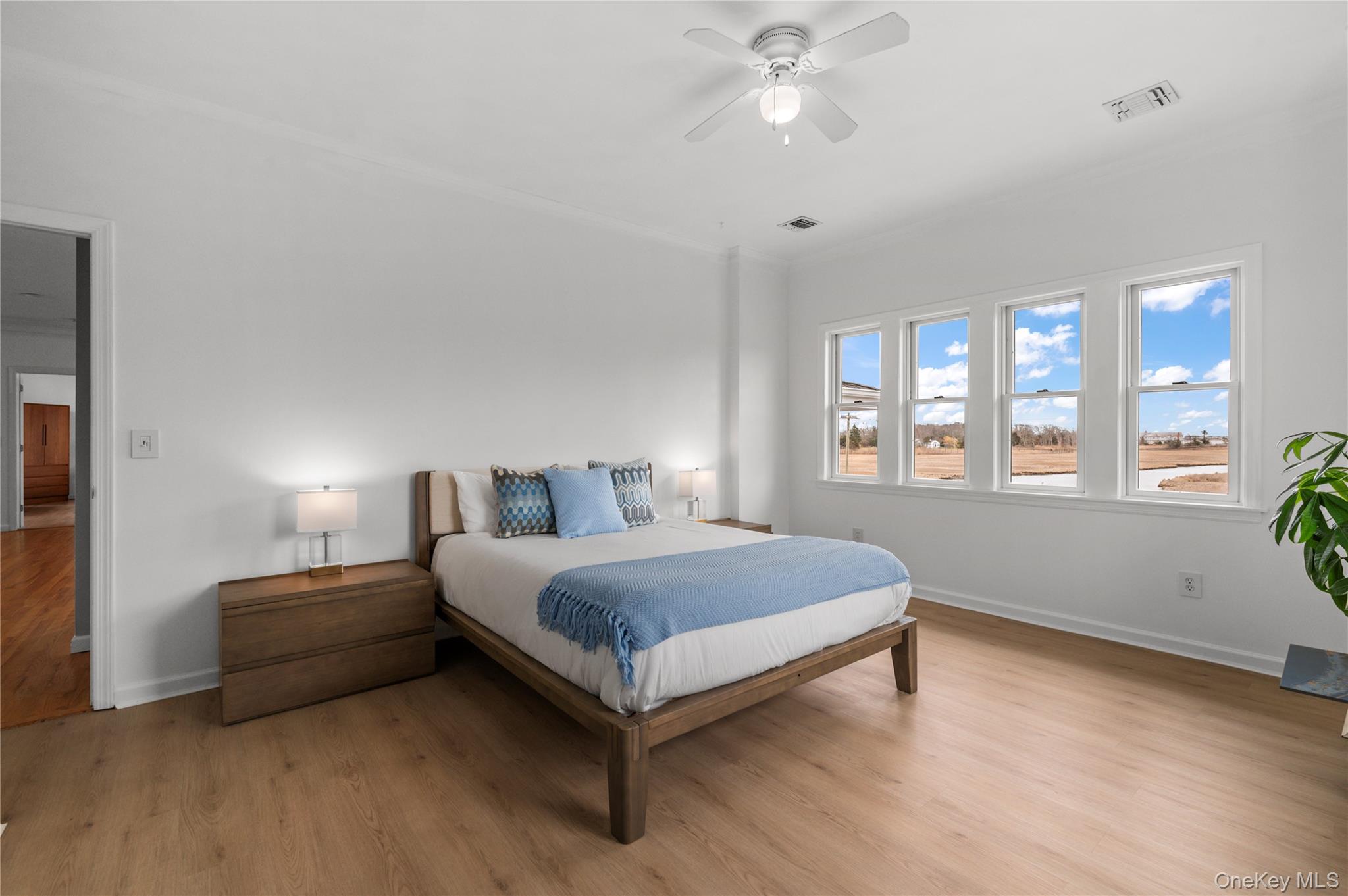 14 South Country Road Westhampton, NY 11977 - Photo 27 of 45 a bedroom with a bed lamp closet and window
