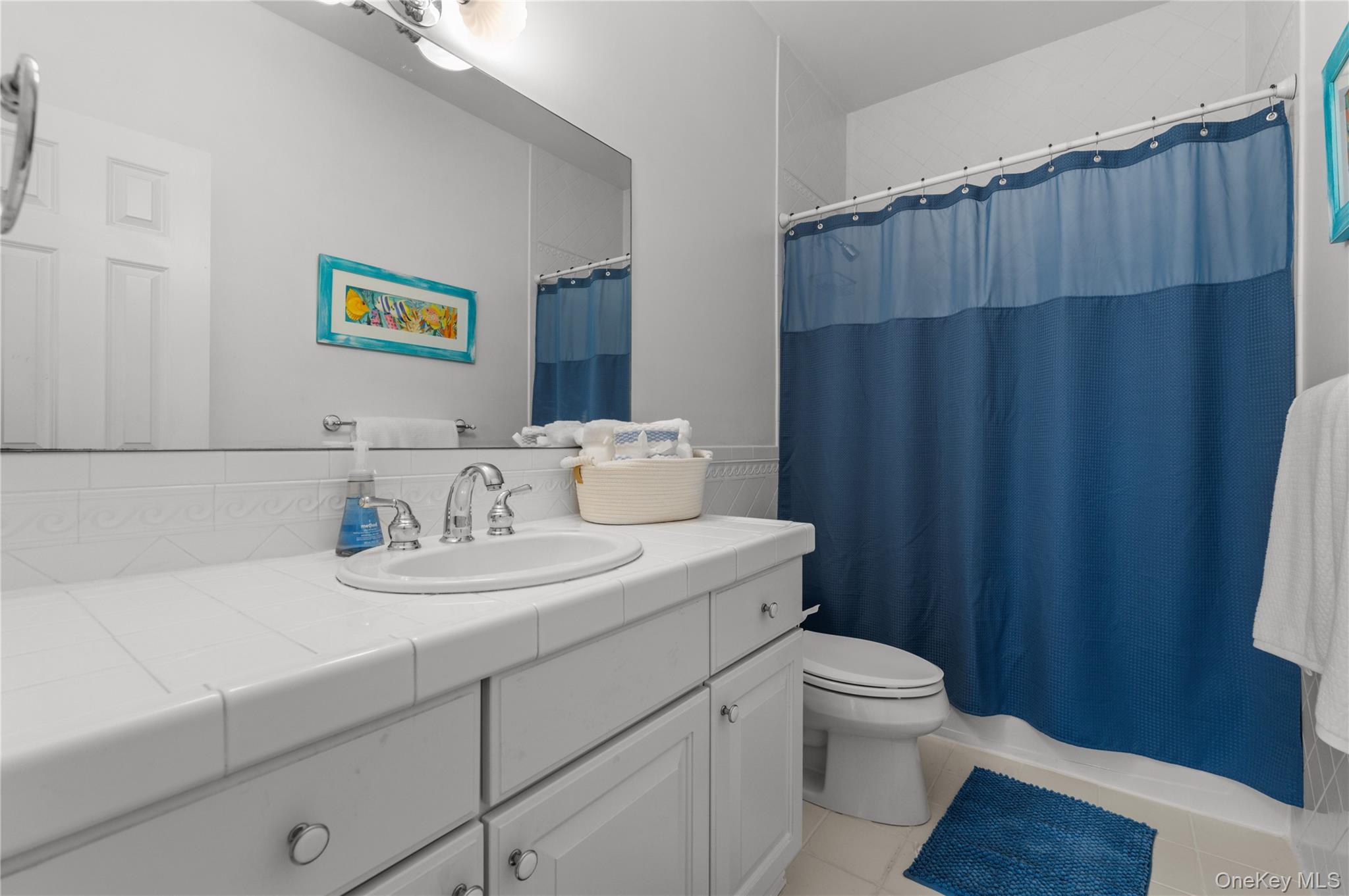 14 South Country Road Westhampton, NY 11977 - Photo 29 of 45 a bathroom with a sink a toilet and shower