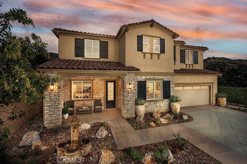 a front view of a house with a yard outdoor seating and garage