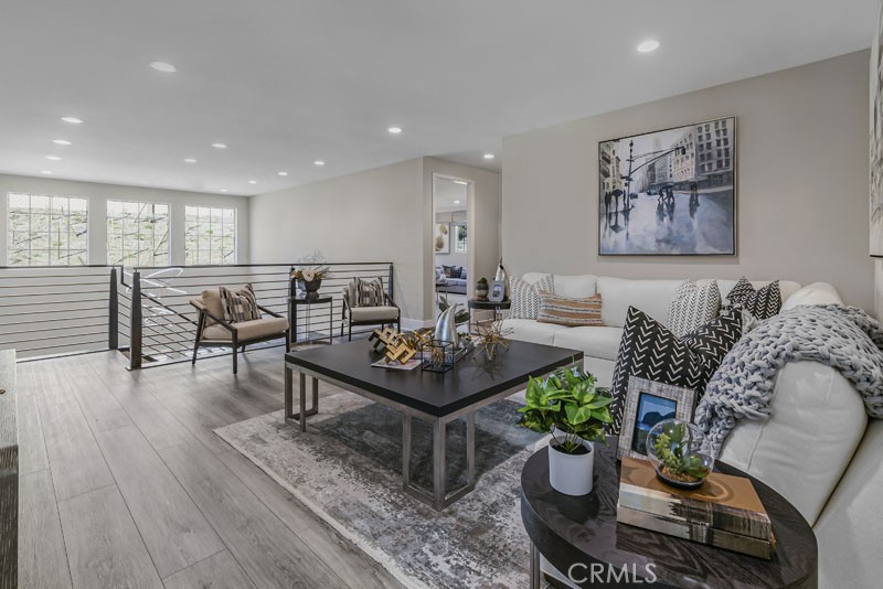6517 Canyon Oaks Drive Simi Valley, CA 93063 - Photo 14 of 35 a living room with furniture a wooden floor and a potted plant