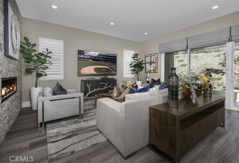 6517 Canyon Oaks Drive Simi Valley, CA 93063 - Photo 22 of 35 a living room with furniture a large window and a fireplace