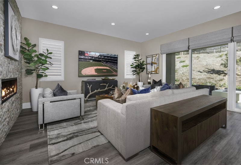 6517 Canyon Oaks Drive Simi Valley, CA 93063 - Photo 10 of 35 a living room with furniture a large window and a fireplace