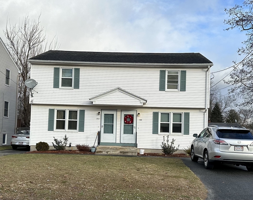153-155 Arnold Avenue Springfield, MA 01119 - Photo 1 of 17 a front view of a house with a garden