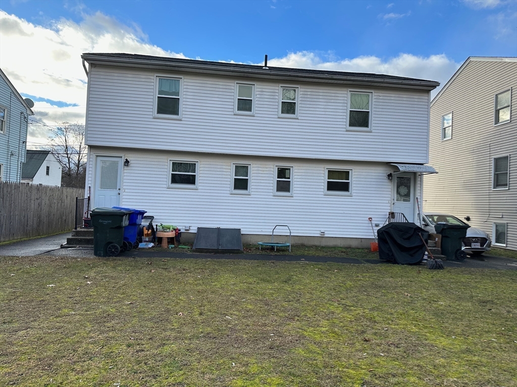 153-155 Arnold Avenue Springfield, MA 01119 - Photo 17 of 17 a front view of a house with a garden and plants