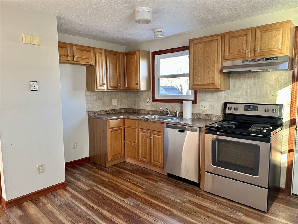 153-155 Arnold Avenue Springfield, MA 01119 - Photo 7 of 17 a kitchen with cabinets appliances and a window