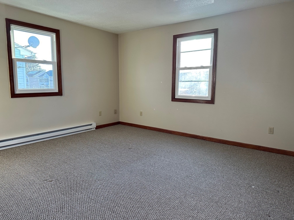 153-155 Arnold Avenue Springfield, MA 01119 - Photo 10 of 17 an empty room with windows