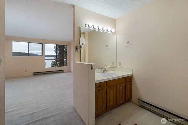 a view of a bathroom with a sink and mirror