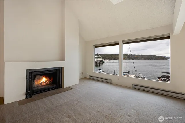 an empty room with a fireplace and window