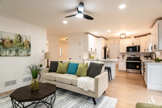 a living room with furniture kitchen and a table