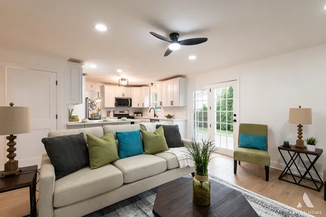 a living room with furniture and a view of kitchen