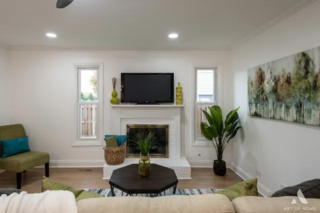 a living room with furniture a fireplace and a flat screen tv