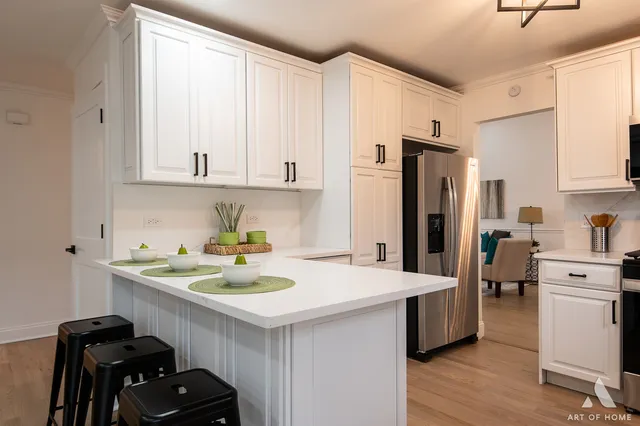 a kitchen with stainless steel appliances a sink a stove and refrigerator