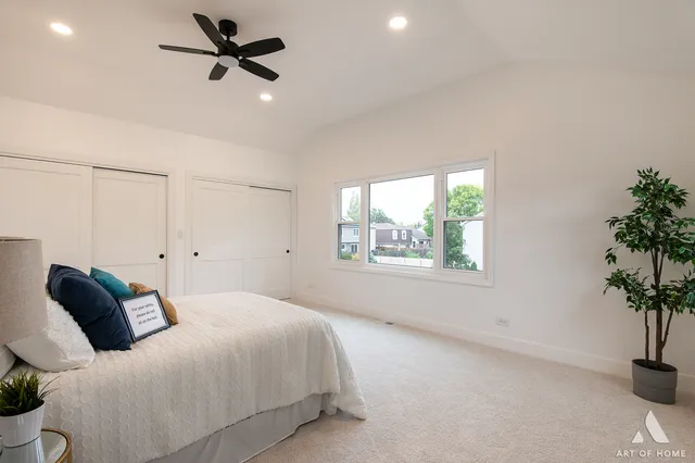 a bedroom with a bed and a potted plant