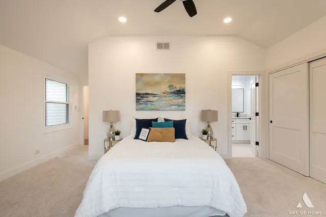 a bedroom with a bed and painting on the wall