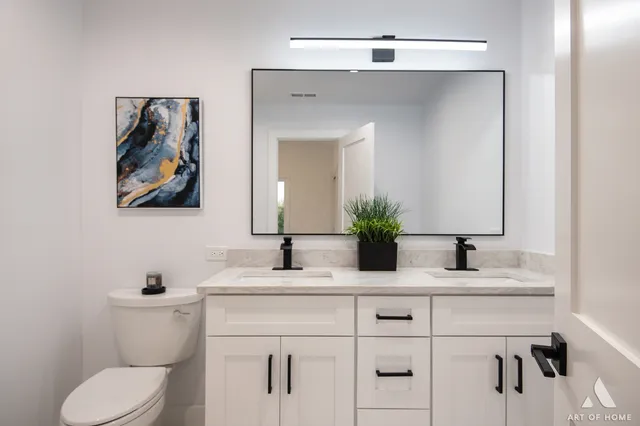 a bathroom with a toilet sink and mirror
