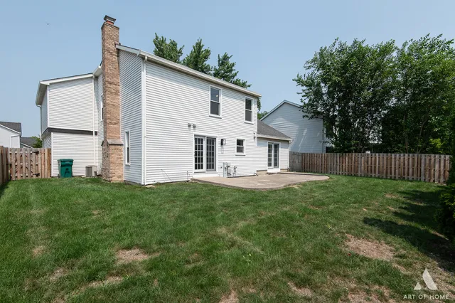 a view of a house with backyard and a garden