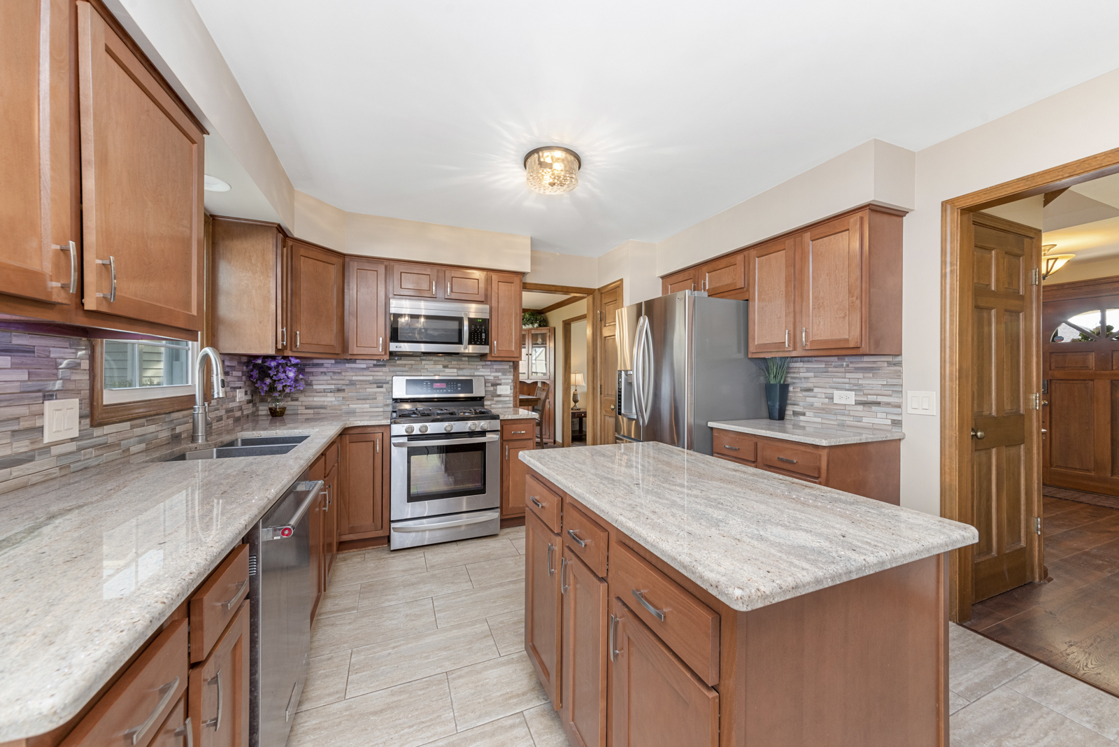 27W344 Churchill Road Winfield, IL 60190 - Photo 8 of 26 a kitchen with granite countertop a sink counter top space appliances and cabinets