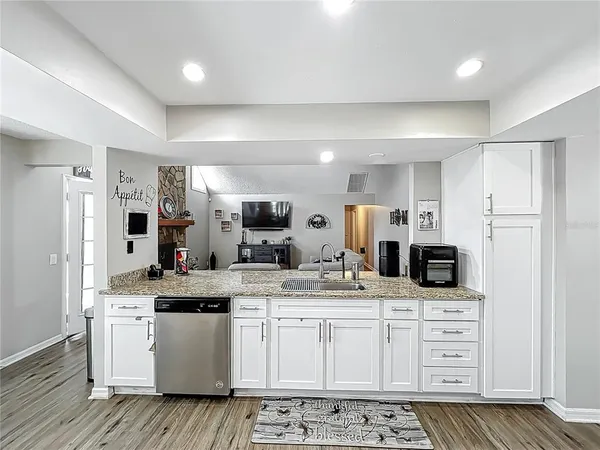 a view of kitchen with sink microwave and refrigerator