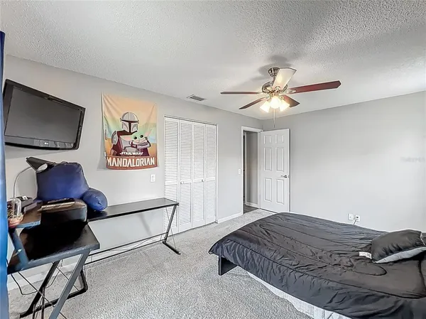 a bedroom with a bed and a chandelier