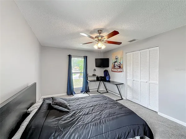a bedroom with a bed and a chandelier