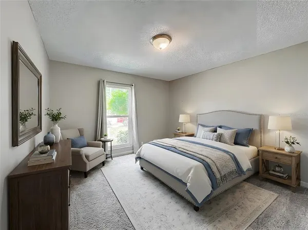 a bedroom with a bed and a couch