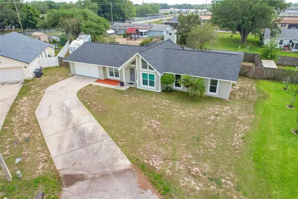 an aerial view of a house with a yard