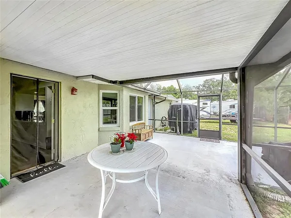 a backyard of a house with table and chairs