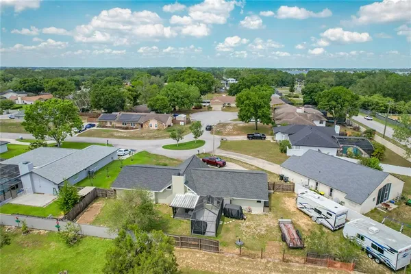 an aerial view of a house with yard swimming pool and outdoor seating