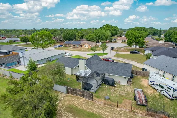 an aerial view of a house with garden space and street view