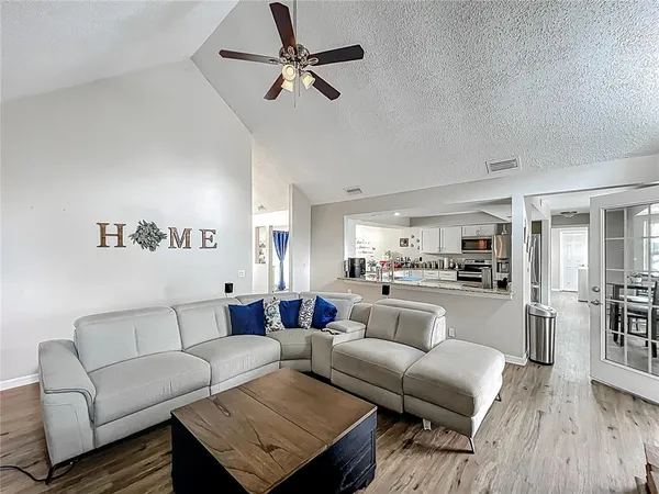 a view of living room kitchen with furniture and wooden floor