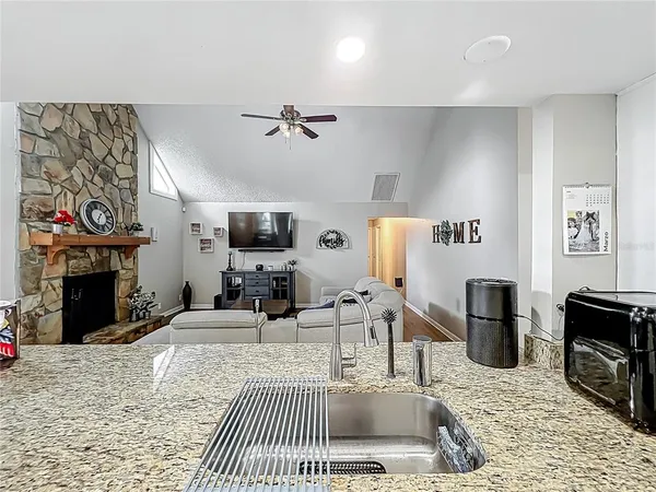 a living room with furniture a fireplace and flat screen tv