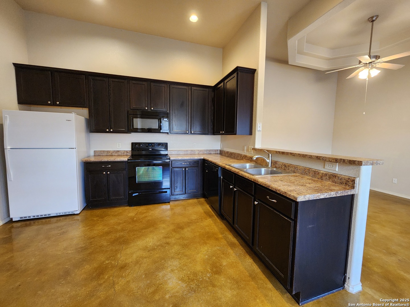 210 Anne Louise Drive New Braunfels, TX 78130 - Photo 5 of 18 a kitchen with stainless steel appliances granite countertop a stove a sink and a refrigerator