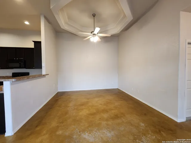 a view of an empty room with a ceiling fan