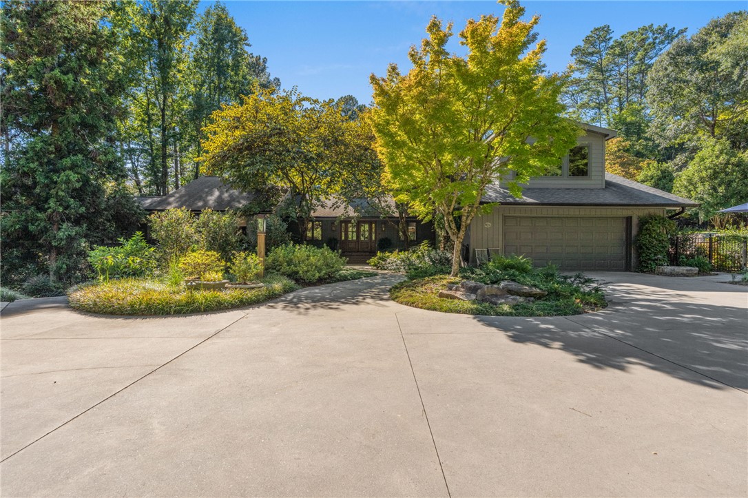 604 Ridgecrest Drive Clemson, SC 29631 - Photo 6 of 50 Lush landscaping and a broad concrete driveway frame this wooded multi-level residence.