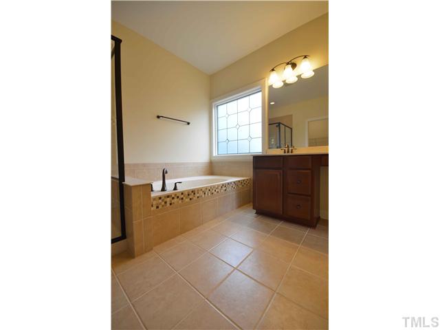 3019 Red Grape Drive Raleigh, NC 27607 - Photo 12 of 22 a bathroom with a bathtub and a sink