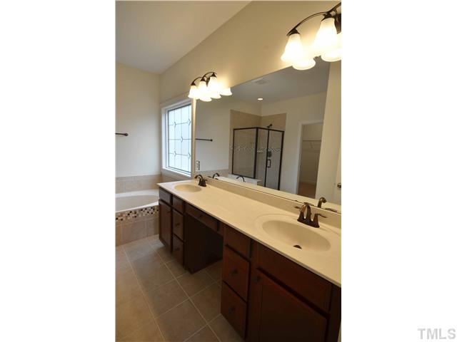 3019 Red Grape Drive Raleigh, NC 27607 - Photo 13 of 22 a bathroom with a sink double vanity and a mirror