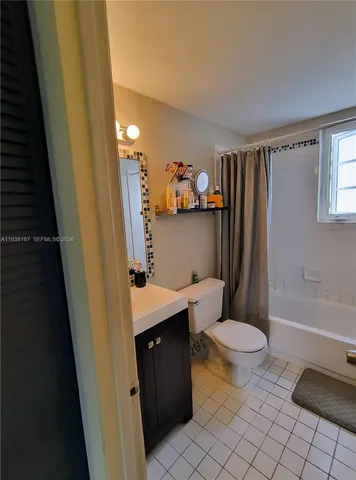 a bathroom with a sink a toilet a tub and shower