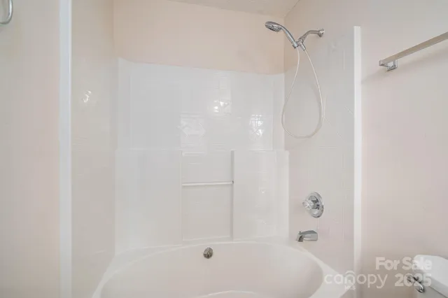 a bathroom with a bathtub and shower