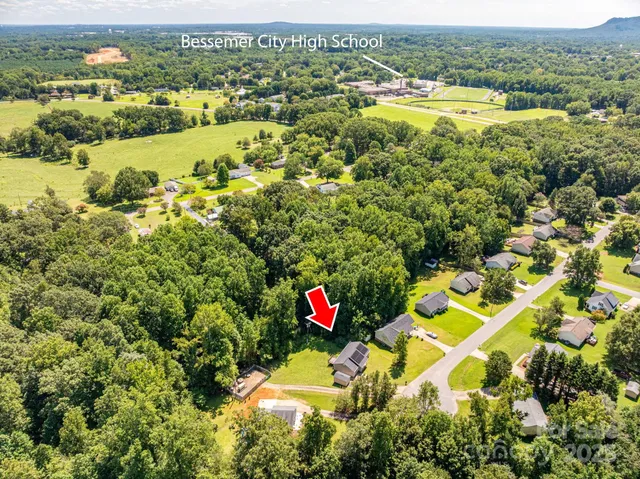 an aerial view of residential houses with outdoor space and swimming pool