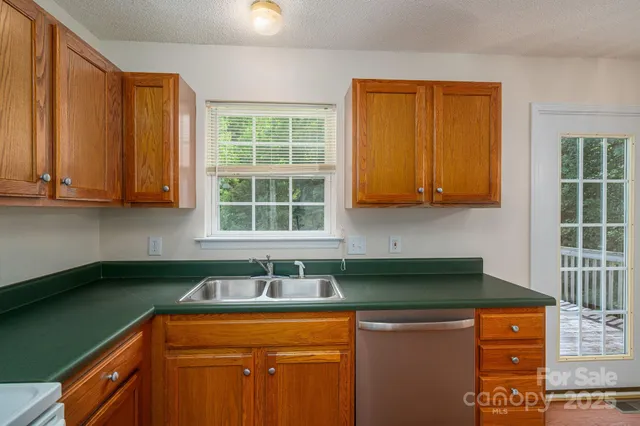 a kitchen with stainless steel appliances granite countertop a sink stove and cabinets