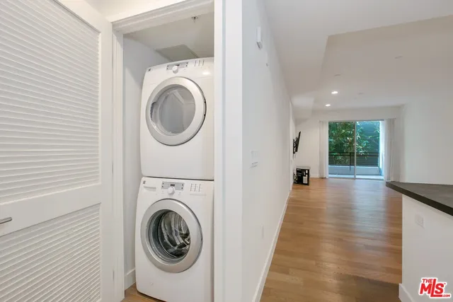 a view of a hallway with washer and dryer