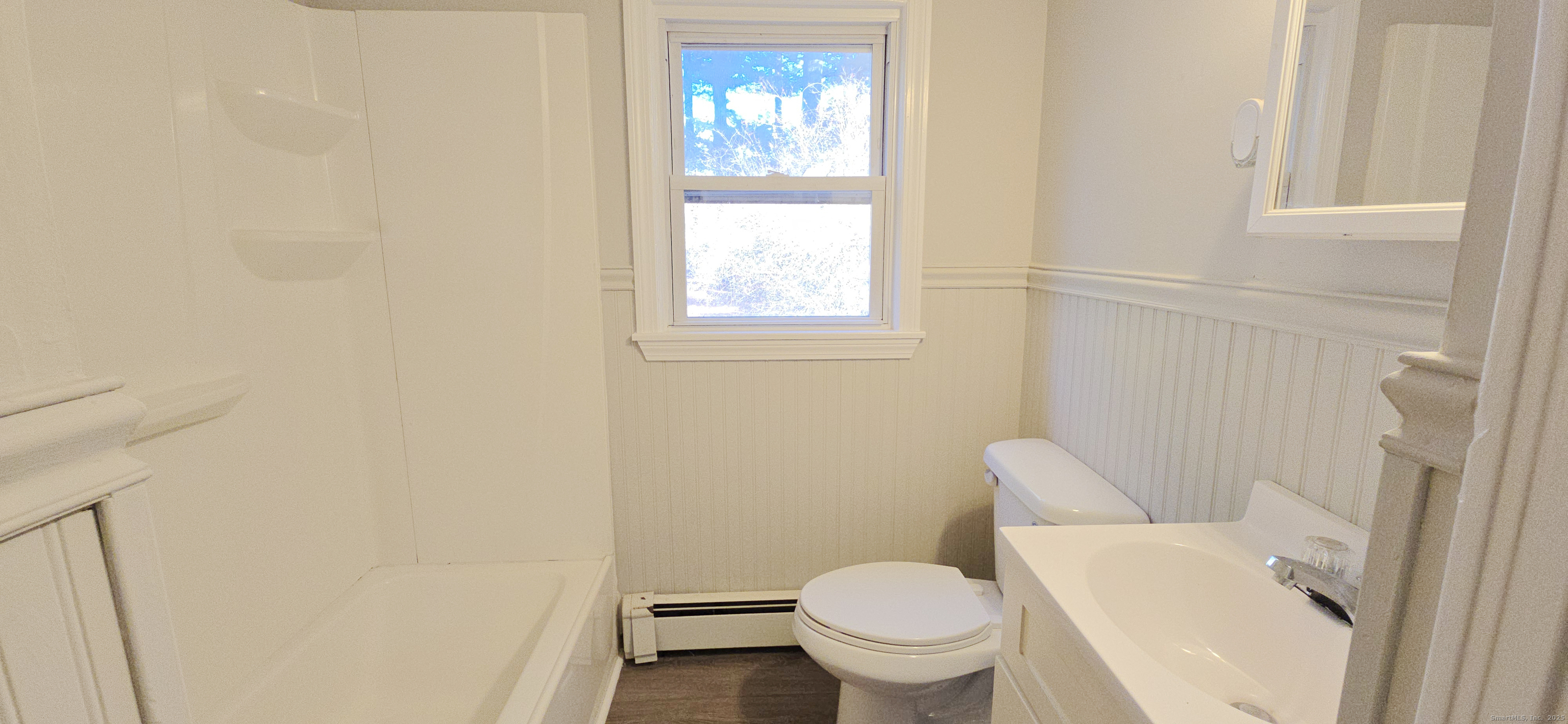 14 West Forrest Drive Enfield, CT 06082 - Photo 12 of 15 a white toilet sitting next to a window