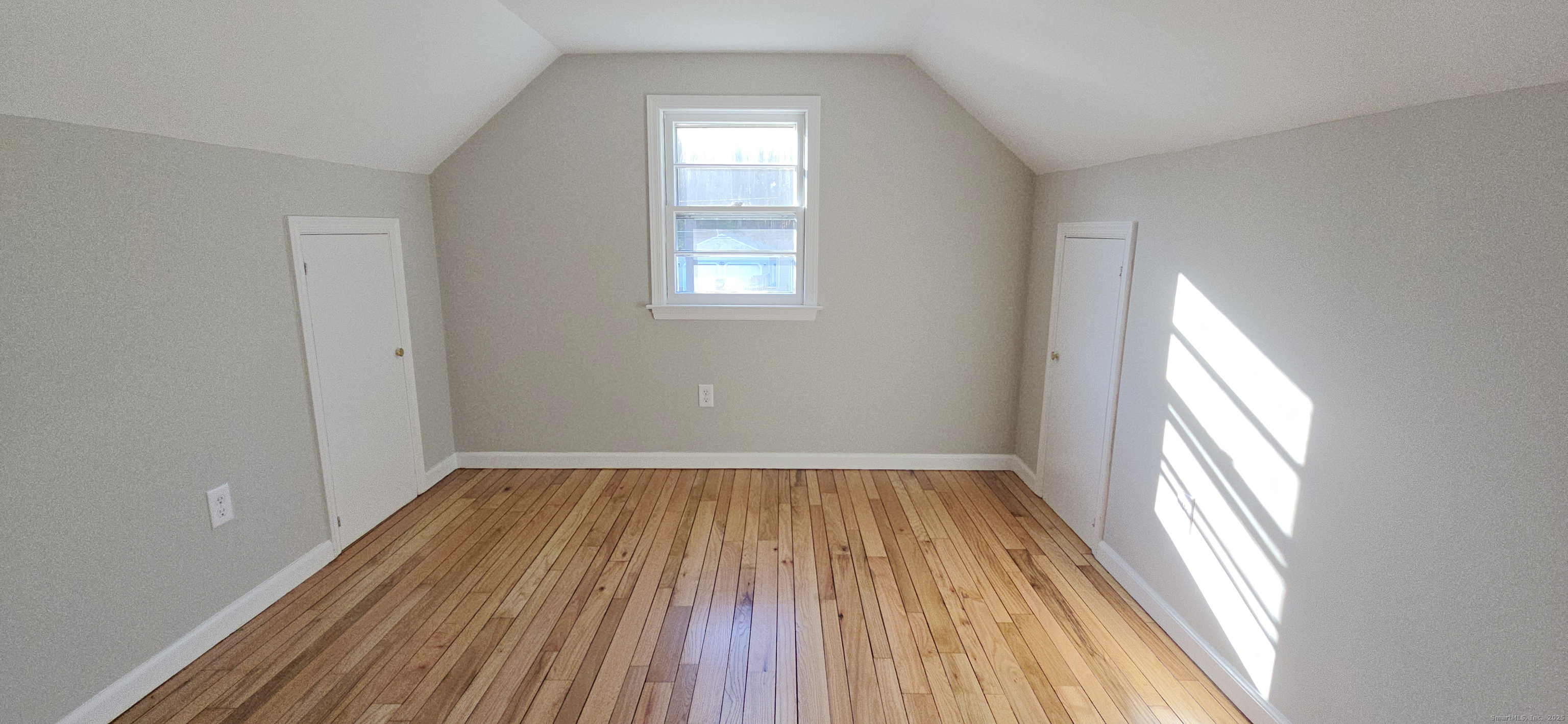 14 West Forrest Drive Enfield, CT 06082 - Photo 14 of 15 a view of an empty room with wooden floor and a window