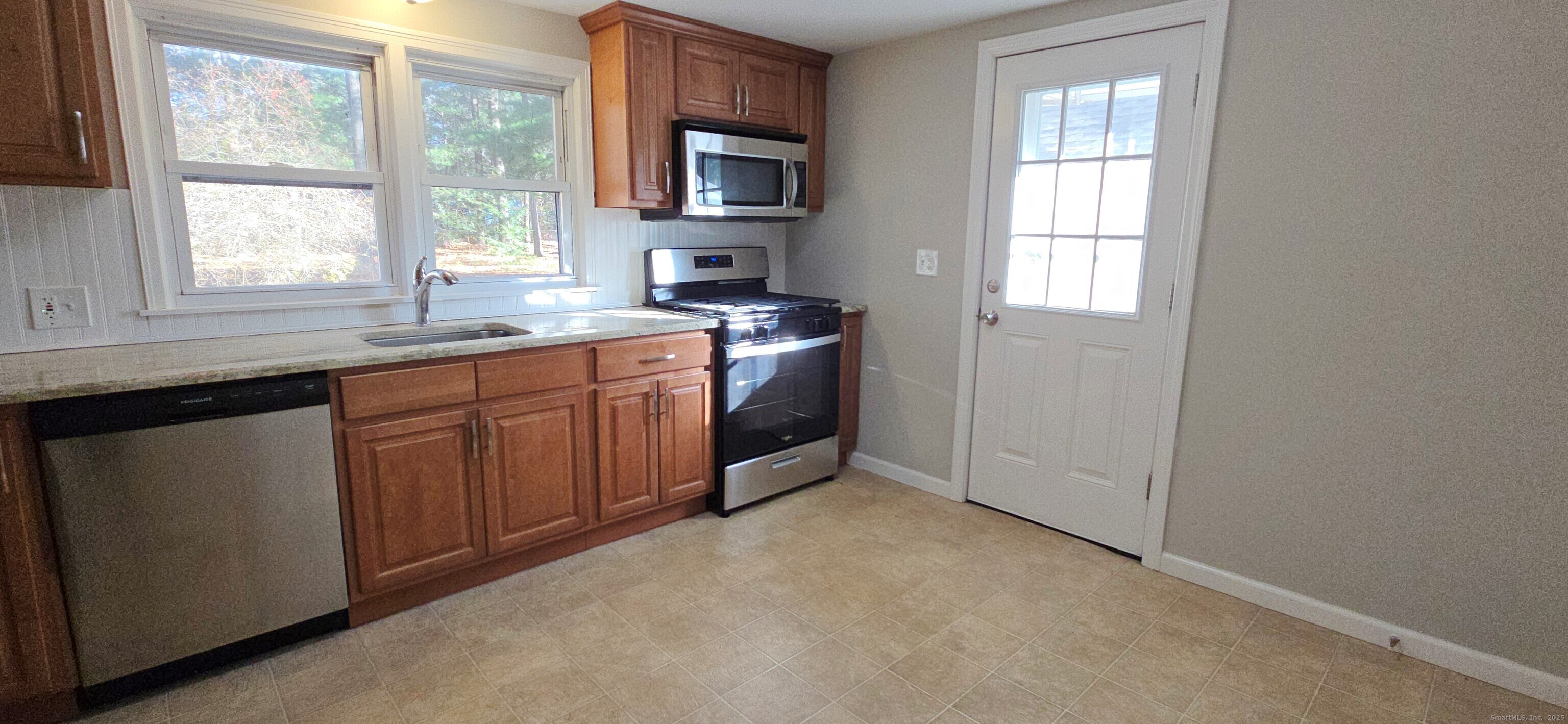 14 West Forrest Drive Enfield, CT 06082 - Photo 8 of 15 a kitchen with stainless steel appliances granite countertop a stove a sink and a window