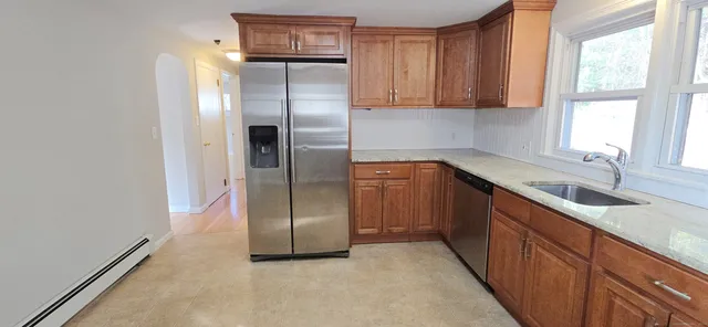 a kitchen with stainless steel appliances granite countertop a refrigerator and a sink