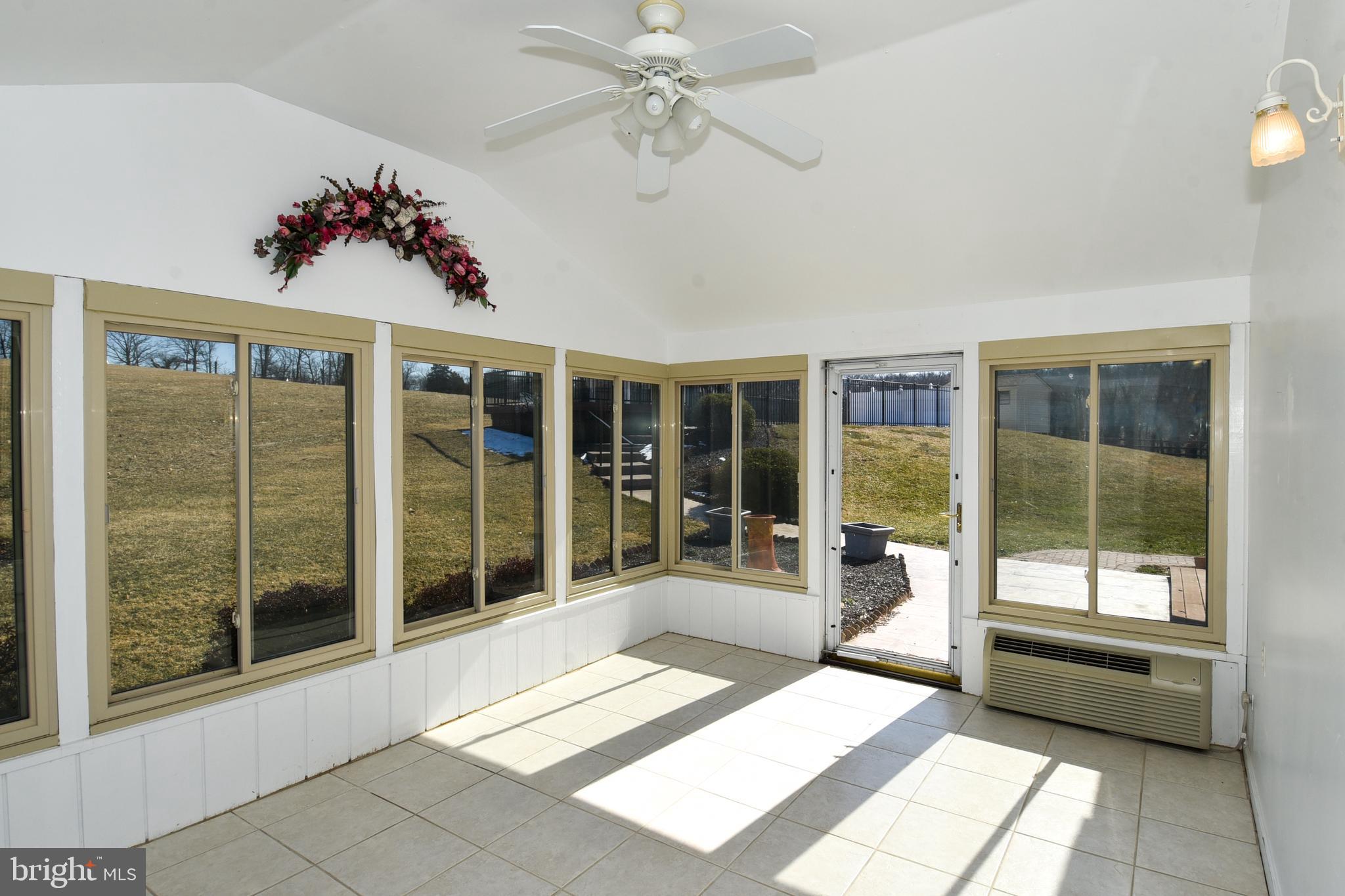 27111 Purdum Road Damascus, MD 20872 - Photo 13 of 84 SUNROOM WALL OF WINDOWS BRING IN NATURAL LIGHT