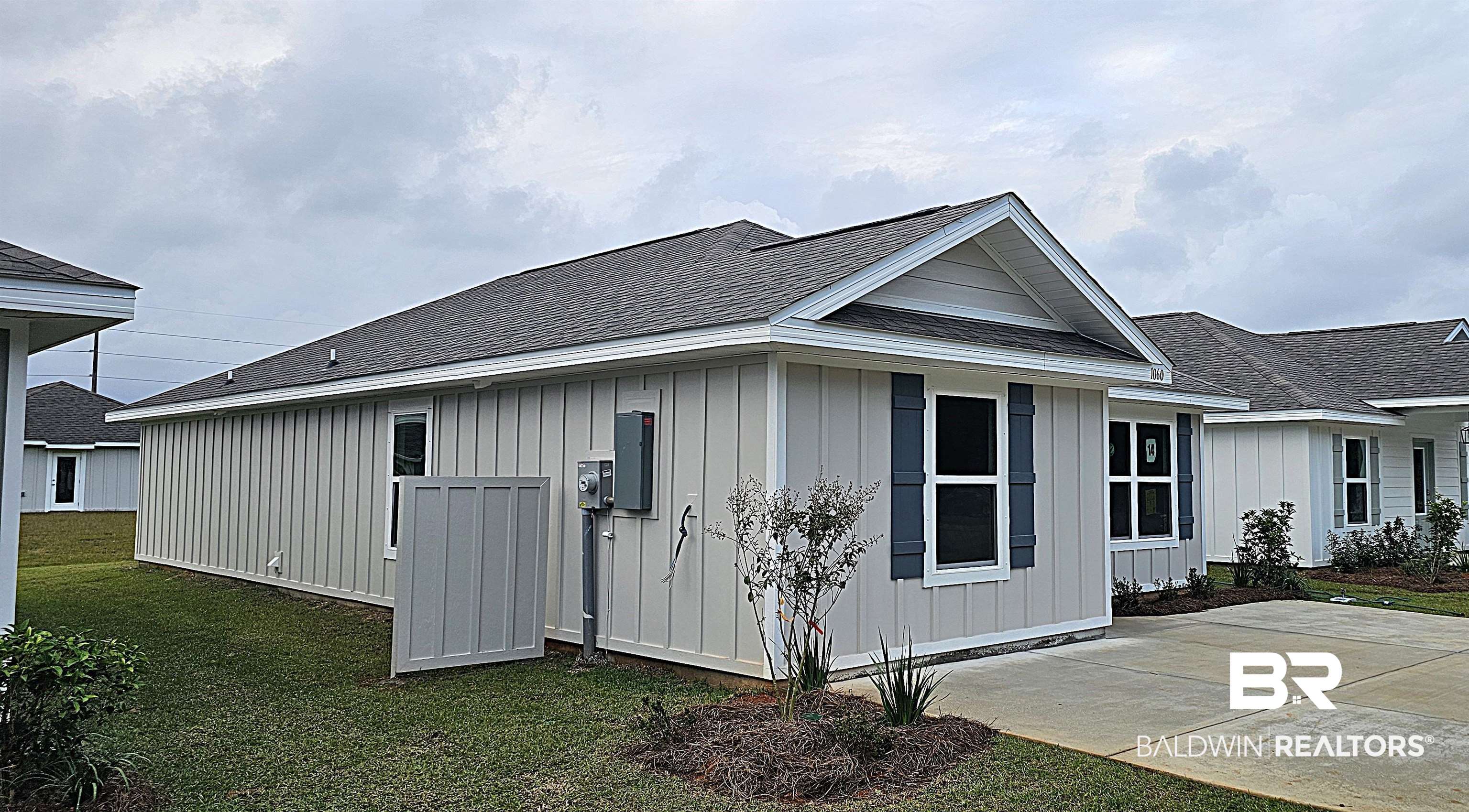 1060 South Bay Street Foley, AL 36535 - Photo 6 of 35 View of side of home with a lawn and a patio